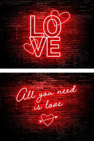 Ama todo lo que necesitas es amar los letreros de neón en una pared de ladrillos. Neon color rojo.